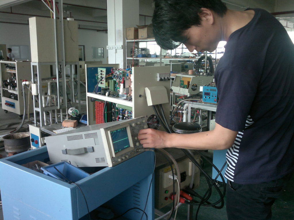 Galaxy Tech skilled technician performing manual signal probing and technical diagnostics in a real-world agile workshop environment.